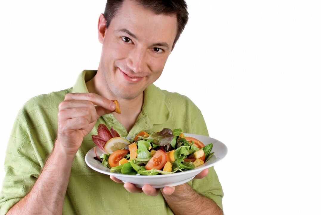 man eating vegetable salad for power